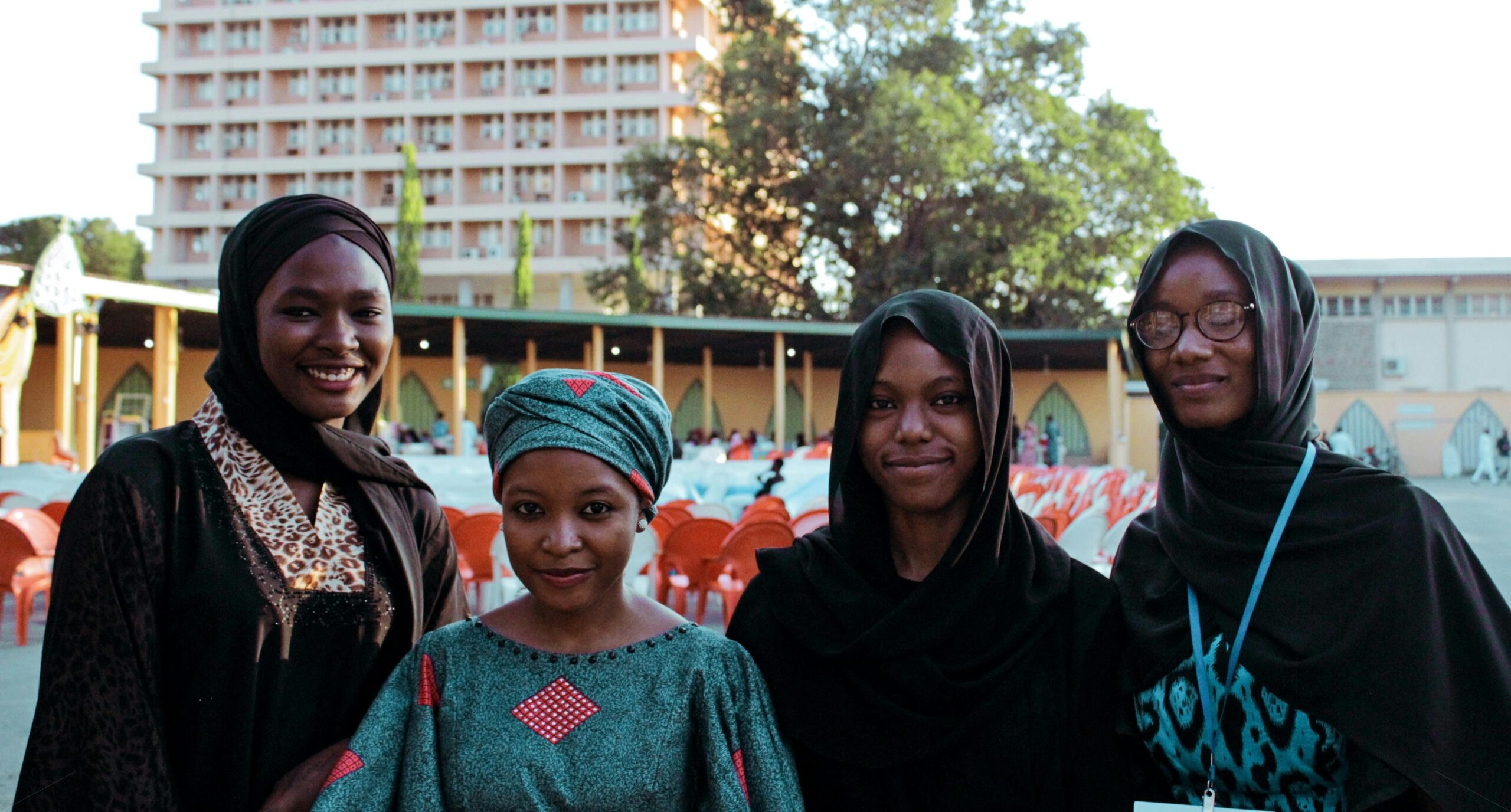 Photo of three Muslim students Wearing Turban and their mother who is wearing hair tie