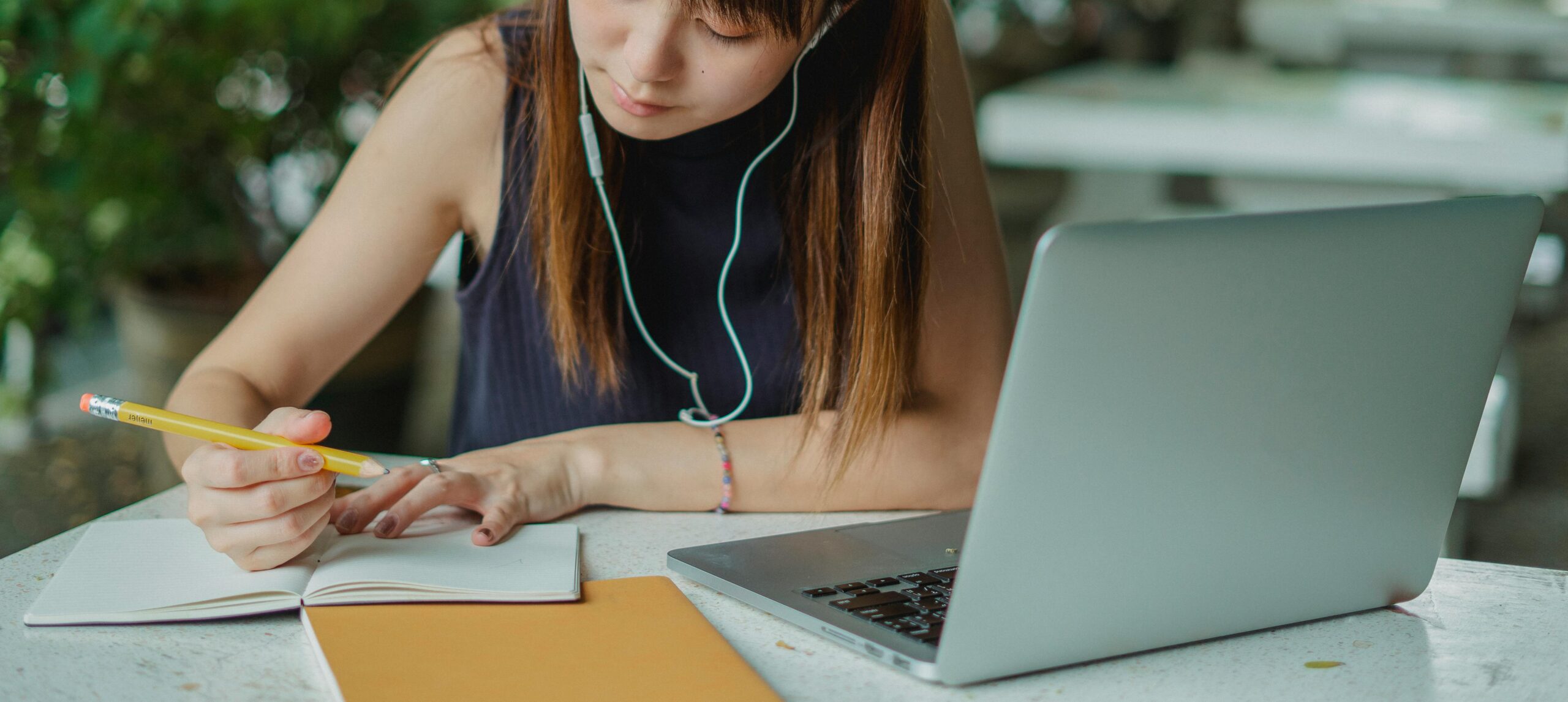 A female College Student Taking Notes from her laptop