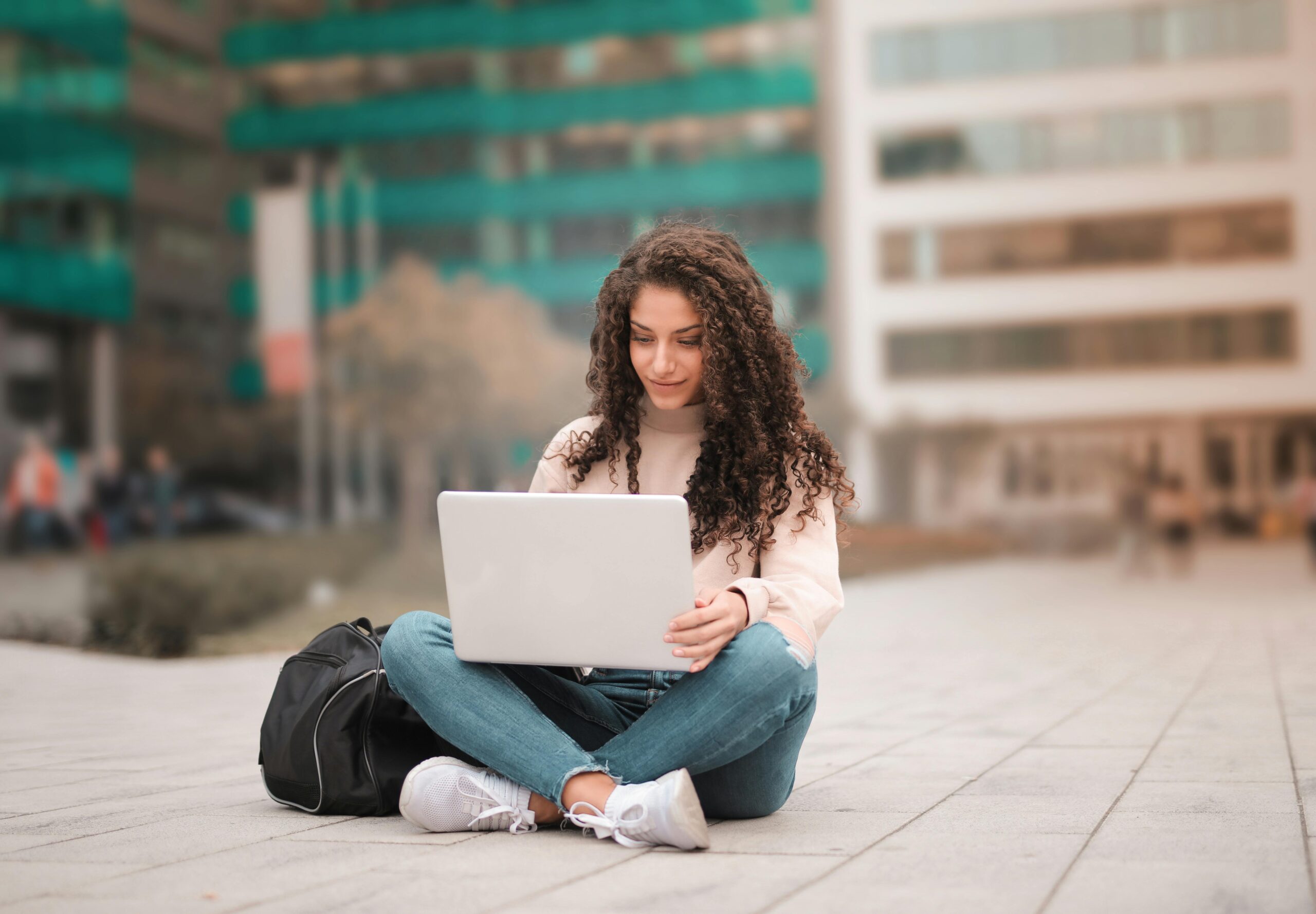 A female student in Pink Sweater Using Laptop