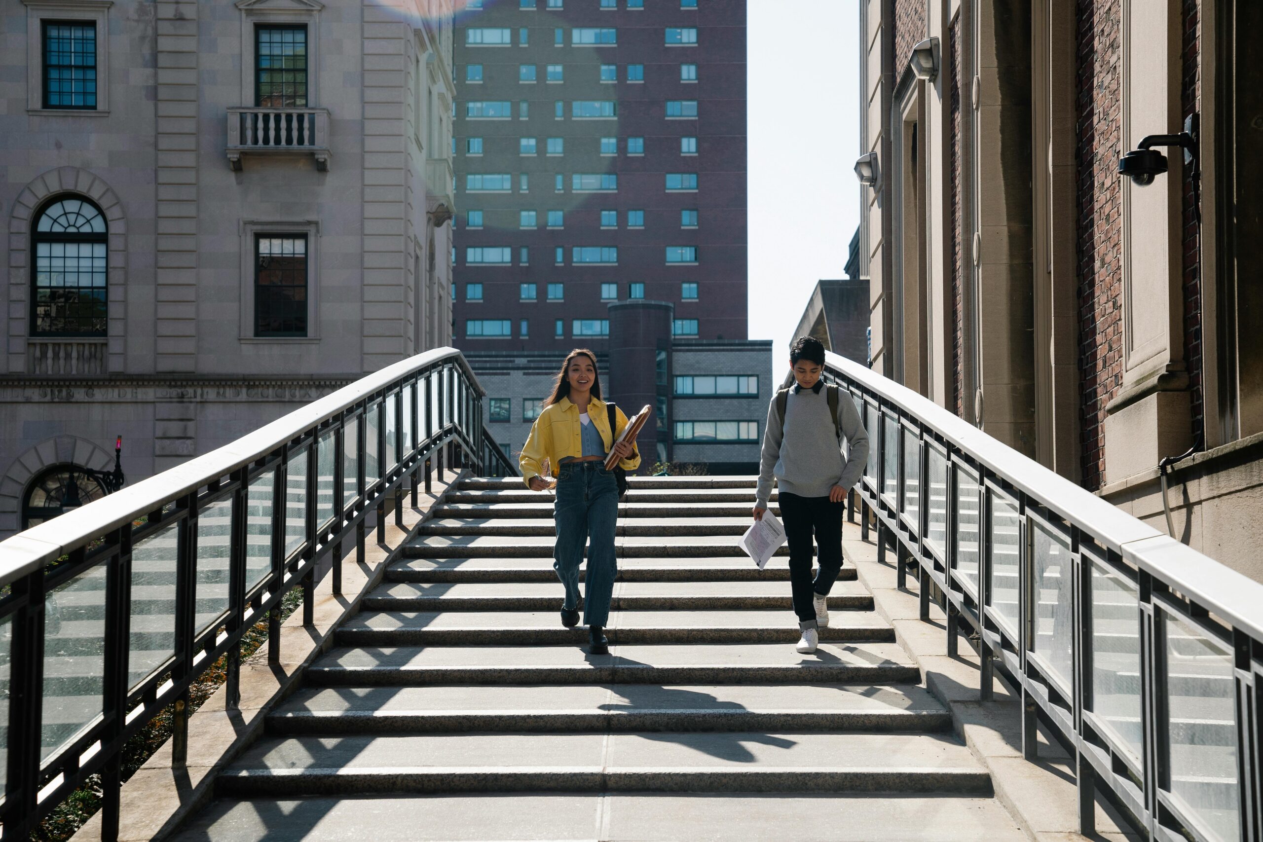 Male and female College students who are friends walking down the street of the city