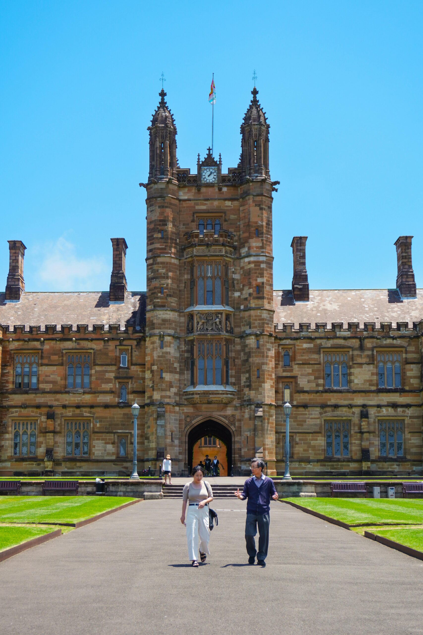 Two college students walking out from a Historic University Building in Sydney, Australia