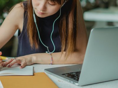 A female College Student Taking Notes from her laptop